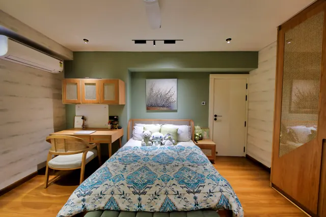 Bedroom with wooden flooring and a writing desk (photograph)
