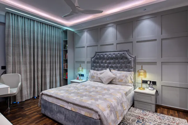 Bedroom with a grey upholstered headboard (photograph)