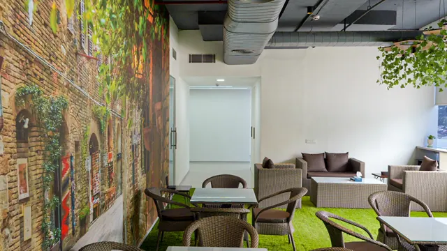 Office café with artificial grass and a mural (photograph)