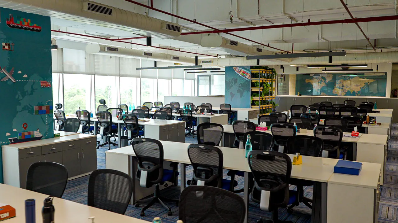 Open-plan office floor with rows of workstations (photograph)